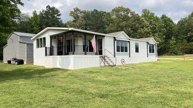 420 Kennedy Rd, Morris Chapel, TN 38361 - manufactured / mobile home featuring a front lawn, a porch, and stairs