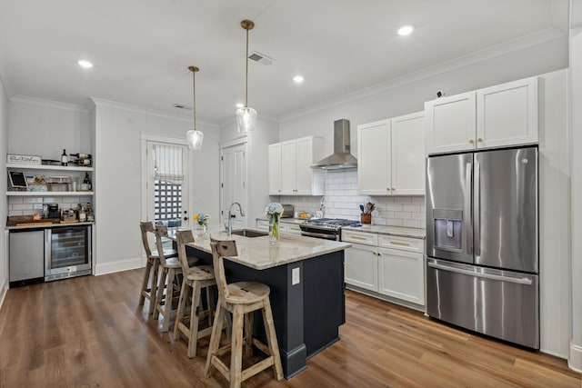 386 Ellsworth St, Memphis, TN 38111 - kitchen with stainless steel appliances, wine cooler, wall chimney range hood, tasteful backsplash, and white cabinetry