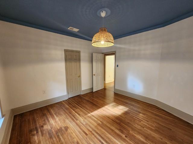 1466 Snowden Ave, Memphis, TN 38107 - spare room featuring wood finished floors and baseboards