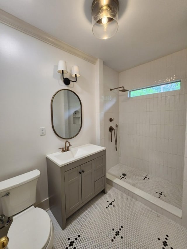 1466 Snowden Ave, Memphis, TN 38107 - bathroom featuring toilet, a tile shower, vanity, tile patterned floors, and ornamental molding