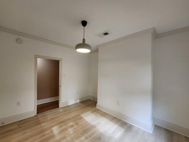 1466 Snowden Ave, Memphis, TN 38107 - spare room with crown molding, light wood-style floors, and baseboards