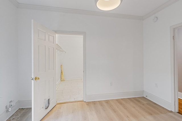 1466 Snowden Ave, Memphis, TN 38107 - unfurnished bedroom featuring light wood-style floors, crown molding, and baseboards