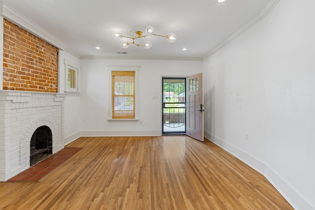 1466 Snowden Ave, Memphis, TN 38107 - unfurnished living room featuring wood-type flooring, crown molding, baseboards, a chandelier, and a fireplace