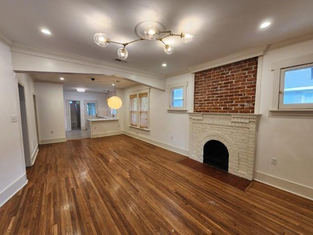1466 Snowden Ave, Memphis, TN 38107 - unfurnished living room with crown molding, hardwood / wood-style floors, baseboards, a fireplace, and recessed lighting