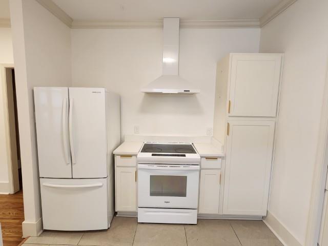 1466 Snowden Ave, Memphis, TN 38107 - kitchen featuring white appliances, wall chimney range hood, white cabinetry, and crown molding