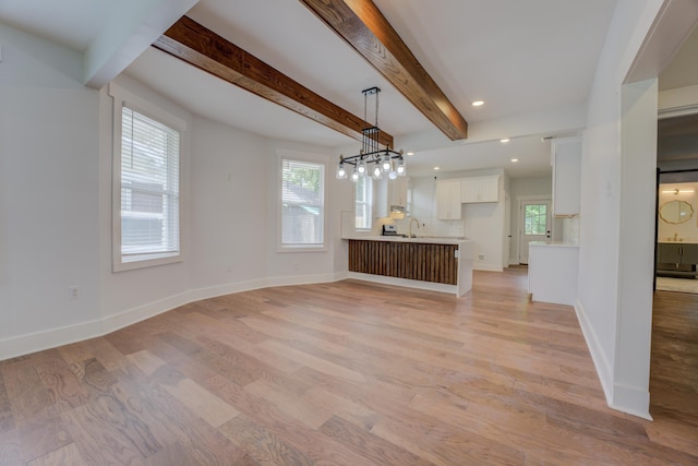 857 E Parkway St, Memphis, TN 38104 - unfurnished living room featuring light wood-style floors, a sink, beamed ceiling, baseboards, and recessed lighting