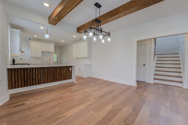857 E Parkway St, Memphis, TN 38104 - unfurnished living room with light wood-style flooring, recessed lighting, stairs, beamed ceiling, and baseboards