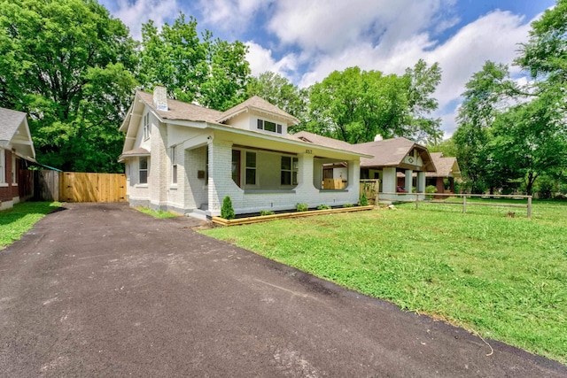 857 E Parkway St, Memphis, TN 38104 - view of front of house featuring a chimney, asphalt driveway, a gate, and brick siding