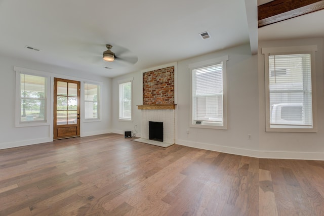 857 E Parkway St, Memphis, TN 38104 - unfurnished living room featuring ceiling fan, wood finished floors, baseboards, and healthy amount of natural light