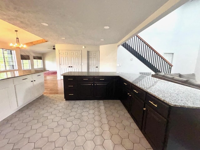 245 Holiday Hills Ln, Counce, TN 38326 - kitchen with open floor plan, recessed lighting, light stone countertops, and a chandelier