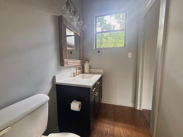 245 Holiday Hills Ln, Counce, TN 38326 - bathroom with toilet, wood finished floors, vanity, and baseboards