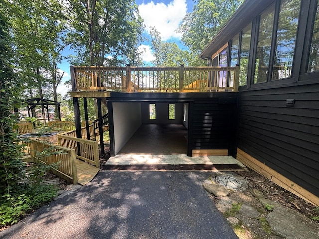 245 Holiday Hills Ln, Counce, TN 38326 - view of property exterior featuring stairs, a deck, asphalt driveway, and an attached carport