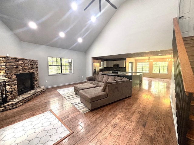 245 Holiday Hills Ln, Counce, TN 38326 - living room featuring high vaulted ceiling, a fireplace, wood-type flooring, and stairs