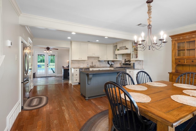 4072 Soderlund Cv, Millington, TN 38053 - dining space featuring a chandelier, dark wood-type flooring, ornamental molding, recessed lighting, and french doors