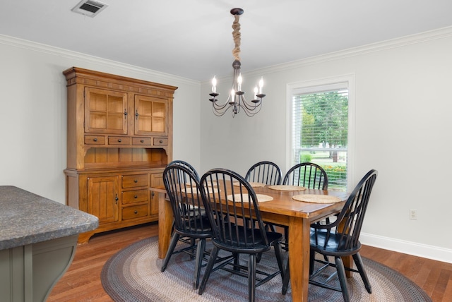 4072 Soderlund Cv, Millington, TN 38053 - dining room with a chandelier, ornamental molding, wood finished floors, and baseboards