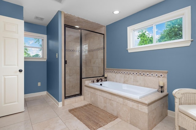 4072 Soderlund Cv, Millington, TN 38053 - full bathroom featuring a bath, a stall shower, plenty of natural light, and tile patterned flooring