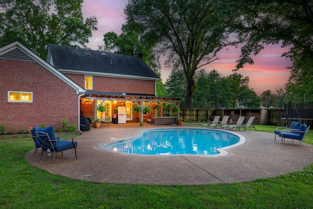 4072 Soderlund Cv, Millington, TN 38053 - pool at dusk featuring a pergola, a patio area, and a trampoline