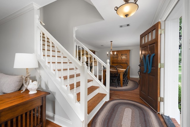 4072 Soderlund Cv, Millington, TN 38053 - entryway featuring stairs, wood finished floors, ornamental molding, a chandelier, and baseboards
