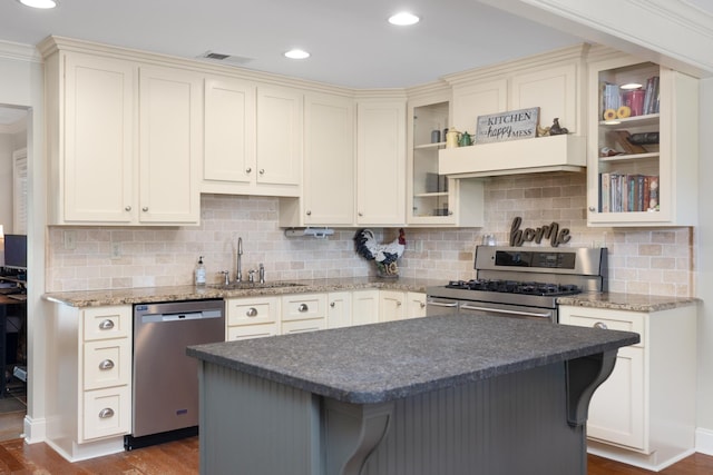 4072 Soderlund Cv, Millington, TN 38053 - kitchen featuring appliances with stainless steel finishes, a sink, dark wood finished floors, tasteful backsplash, and custom exhaust hood