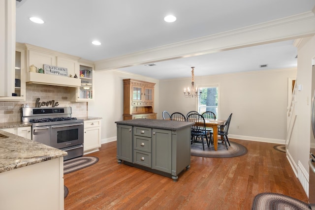 4072 Soderlund Cv, Millington, TN 38053 - kitchen with double oven range, wood finished floors, backsplash, crown molding, and a chandelier