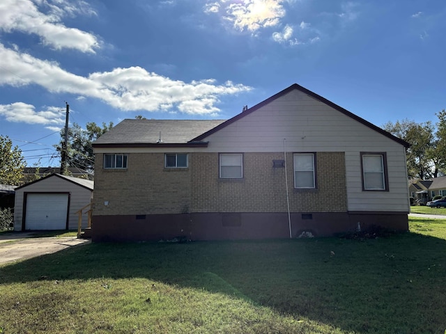 1058 Seymour St, Memphis, TN 38108 - view of side of property with crawl space, brick siding, an outdoor structure, and a yard