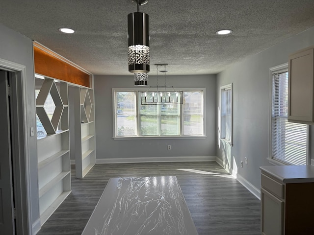 1058 Seymour St, Memphis, TN 38108 - unfurnished dining area with a textured ceiling, dark wood-type flooring, a chandelier, baseboards, and recessed lighting