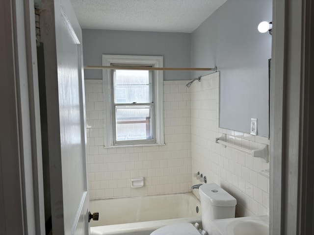 1058 Seymour St, Memphis, TN 38108 - bathroom with toilet, shower / bath combination, tile walls, and a textured ceiling