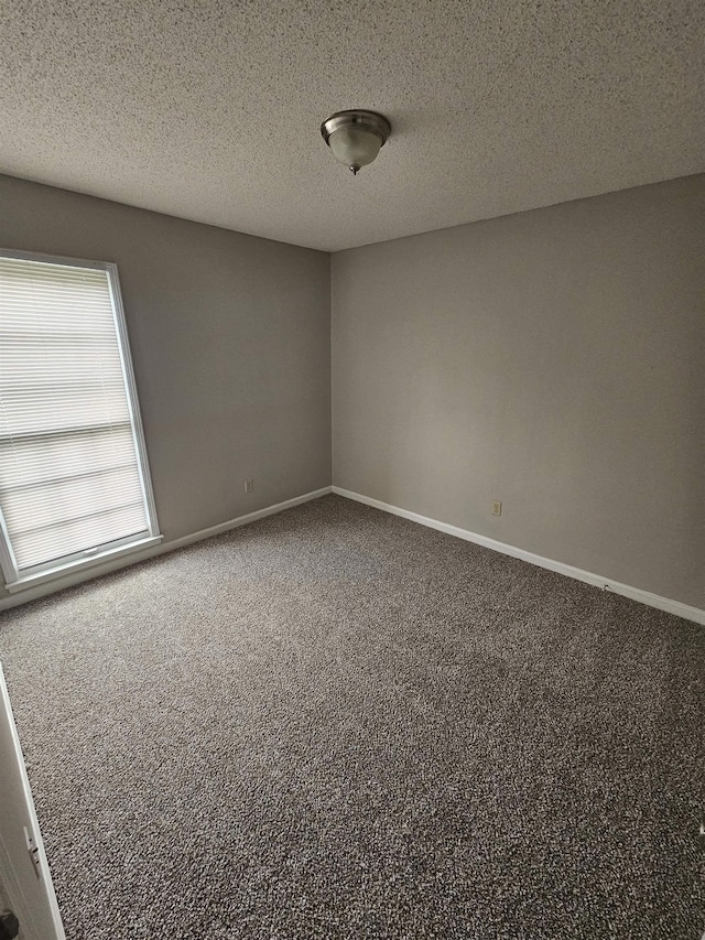 6867 Innsbrook Cv, Memphis, TN 38115 - spare room with carpet floors, baseboards, and a textured ceiling