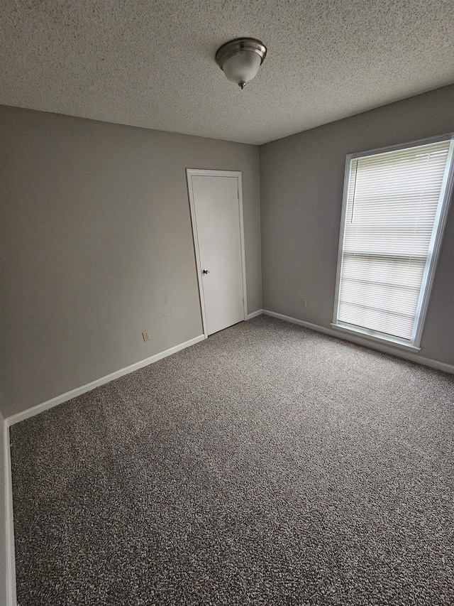 6867 Innsbrook Cv, Memphis, TN 38115 - empty room with carpet flooring, baseboards, and a textured ceiling