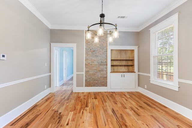 1906 Vollintine Ave, Memphis, TN 38107 - unfurnished dining area featuring a chandelier, light wood-type flooring, ornamental molding, and baseboards