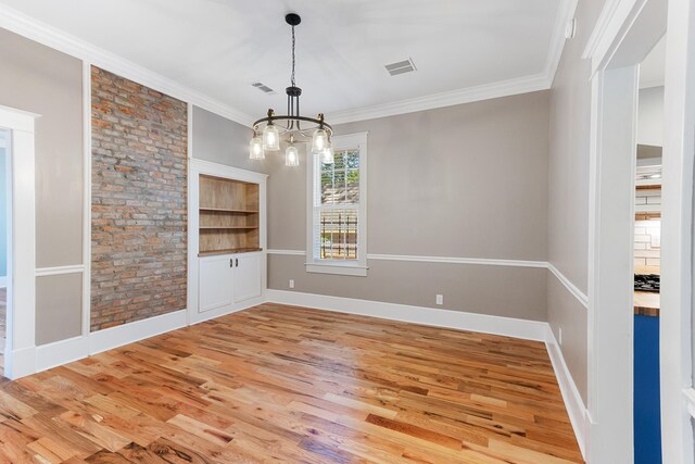 1906 Vollintine Ave, Memphis, TN 38107 - spare room with light wood-type flooring, a chandelier, ornamental molding, and baseboards