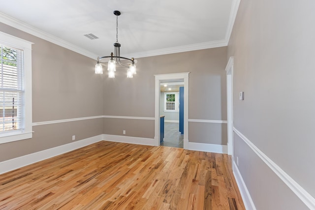 1906 Vollintine Ave, Memphis, TN 38107 - unfurnished room with a chandelier, ornamental molding, light wood-type flooring, and baseboards