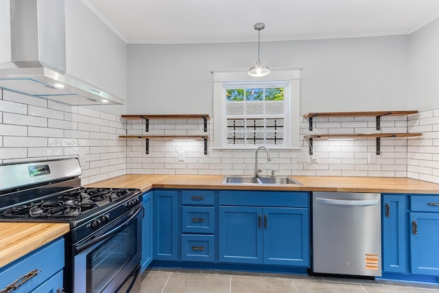1906 Vollintine Ave, Memphis, TN 38107 - kitchen with wood counters, stainless steel appliances, open shelves, wall chimney range hood, and ornamental molding