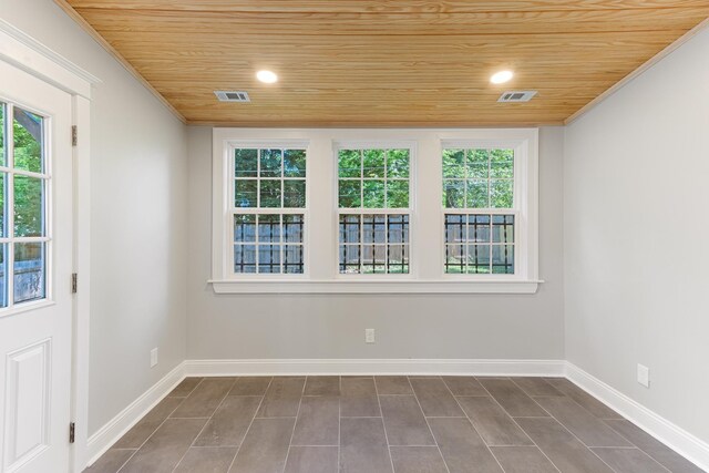 1906 Vollintine Ave, Memphis, TN 38107 - spare room featuring wood ceiling, healthy amount of natural light, baseboards, and ornamental molding