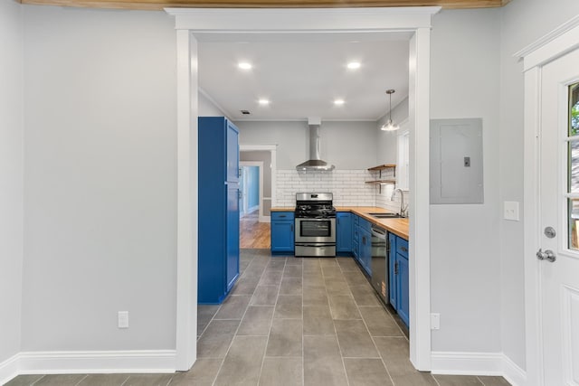 1906 Vollintine Ave, Memphis, TN 38107 - kitchen with blue cabinets, appliances with stainless steel finishes, butcher block counters, wall chimney exhaust hood, and electric panel