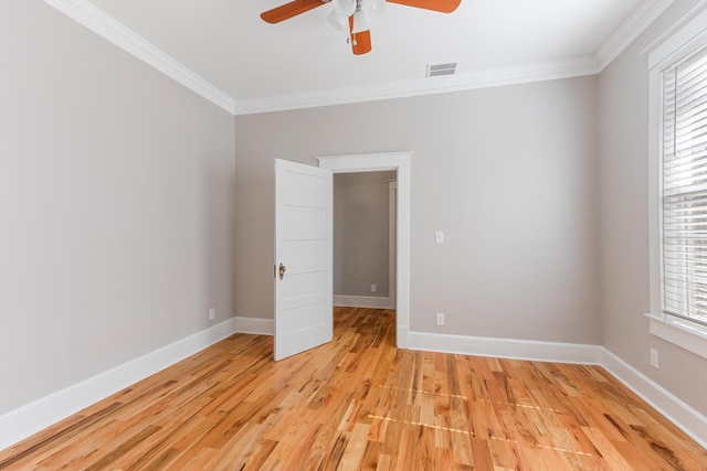1906 Vollintine Ave, Memphis, TN 38107 - spare room featuring ornamental molding, a ceiling fan, light wood-type flooring, healthy amount of natural light, and baseboards