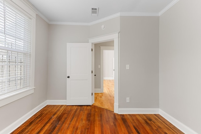1906 Vollintine Ave, Memphis, TN 38107 - spare room with hardwood / wood-style flooring, plenty of natural light, crown molding, and baseboards