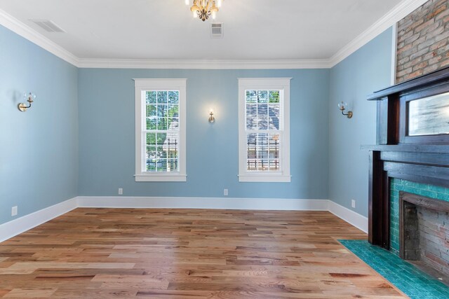 1906 Vollintine Ave, Memphis, TN 38107 - unfurnished living room featuring ornamental molding, a fireplace, wood finished floors, and baseboards