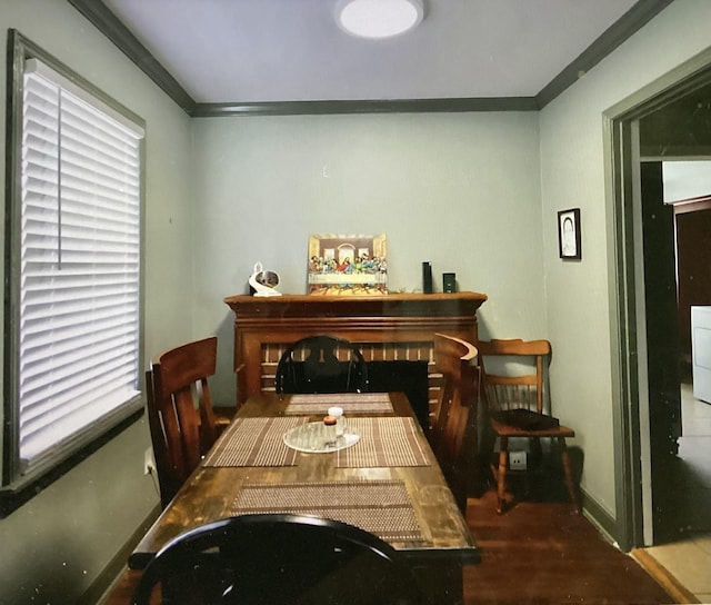 4864 Bowen Ave, Memphis, TN 38122 - dining room featuring crown molding, baseboards, and wood finished floors