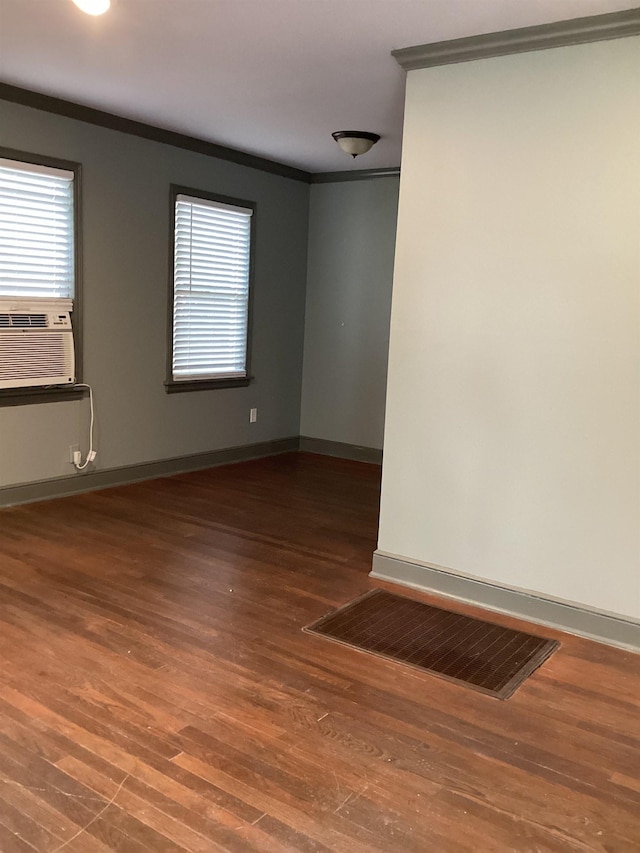 4864 Bowen Ave, Memphis, TN 38122 - spare room featuring crown molding, wood finished floors, cooling unit, and baseboards