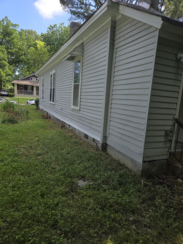 961 Joseph Pl, Memphis, TN 38107 - view of home's exterior featuring a yard, crawl space, and a chimney