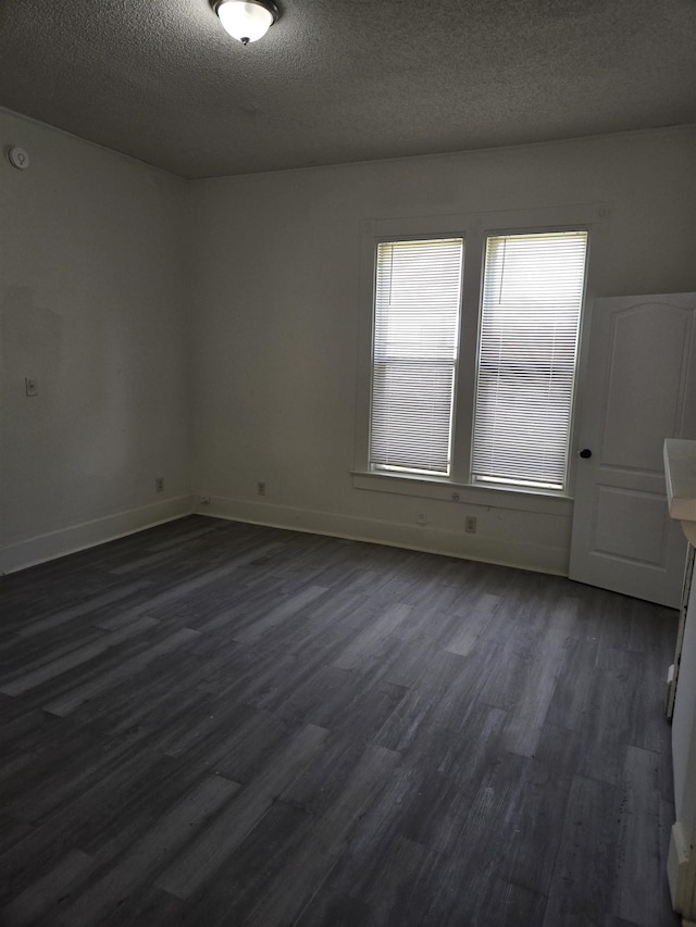 961 Joseph Pl, Memphis, TN 38107 - spare room with dark wood finished floors, a textured ceiling, and baseboards