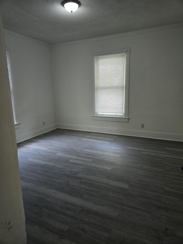 961 Joseph Pl, Memphis, TN 38107 - unfurnished room with a textured ceiling, dark wood-style flooring, baseboards, and ornamental molding
