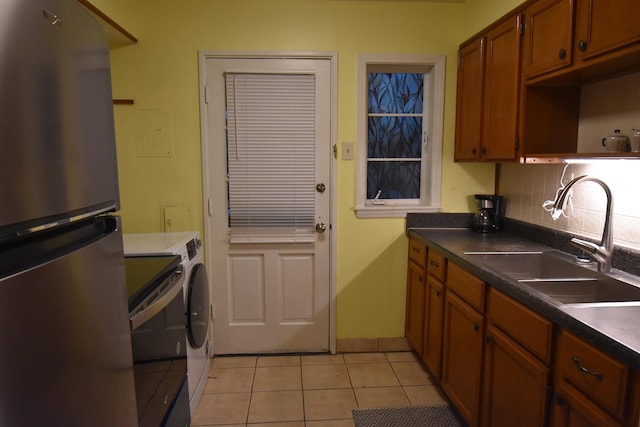 3007 Walnut Grove Rd Unit 1, Memphis, TN 38111 - kitchen featuring freestanding refrigerator, a sink, washer and dryer, range, and light tile patterned flooring