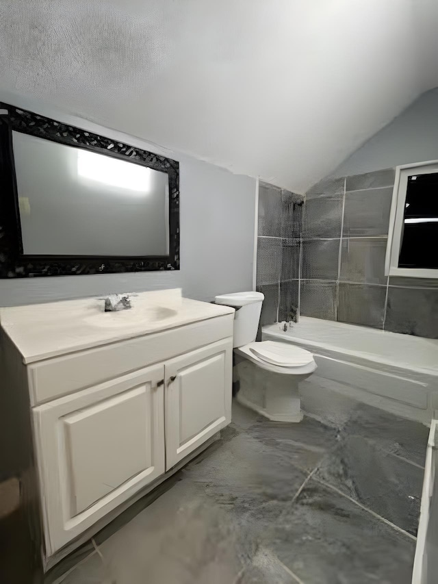 929 N Watkins St, Memphis, TN 38107 - bathroom featuring vaulted ceiling, toilet, vanity, shower / bath combination, and marble finish flooring