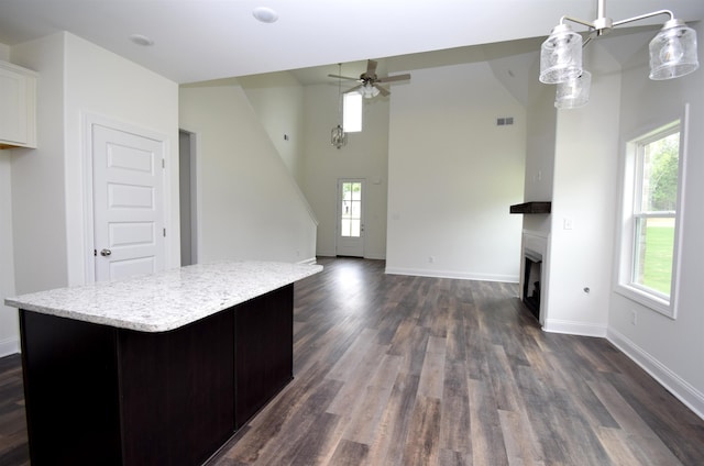 117 Centerline Roper Loop, Byhalia, MS 38611 - unfurnished living room featuring ceiling fan, dark wood-type flooring, a fireplace, baseboards, and a high ceiling