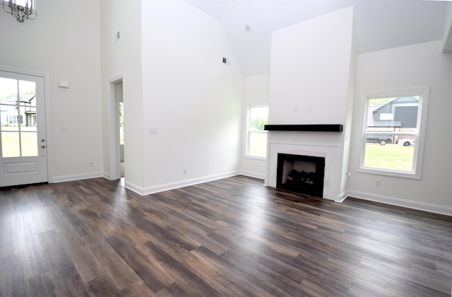 117 Centerline Roper Loop, Byhalia, MS 38611 - unfurnished living room featuring high vaulted ceiling, plenty of natural light, dark wood-type flooring, a fireplace, and baseboards