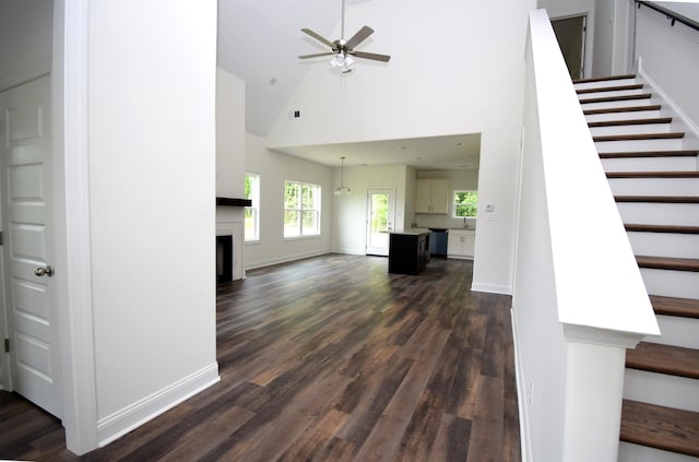 117 Centerline Roper Loop, Byhalia, MS 38611 - unfurnished living room featuring stairs, dark wood-type flooring, high vaulted ceiling, a ceiling fan, and baseboards