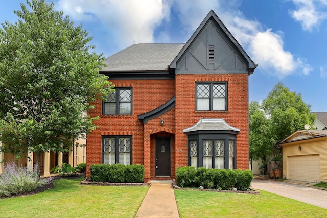 1870 Peabody Green Dr, Memphis, TN 38104 - view of front of house featuring brick siding, a front yard, a garage, and driveway