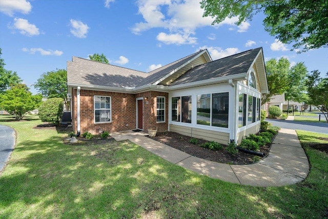 1961 Appling Oaks Cir Unit 29, Cordova, TN 38016 - view of front of home with brick siding, a front yard, a sunroom, and roof with shingles